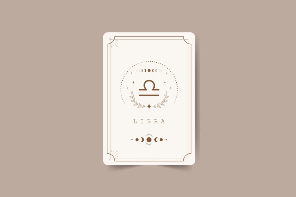 ilustração de uma carta branca com símbolo do signo de libra marrom com pontos em volta, nome do signo em inglês embaixo e desenhos de lua. carta está em fundo marrom-claro