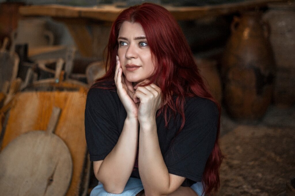 Mulher de cabelo ruivo sentada em um sofá