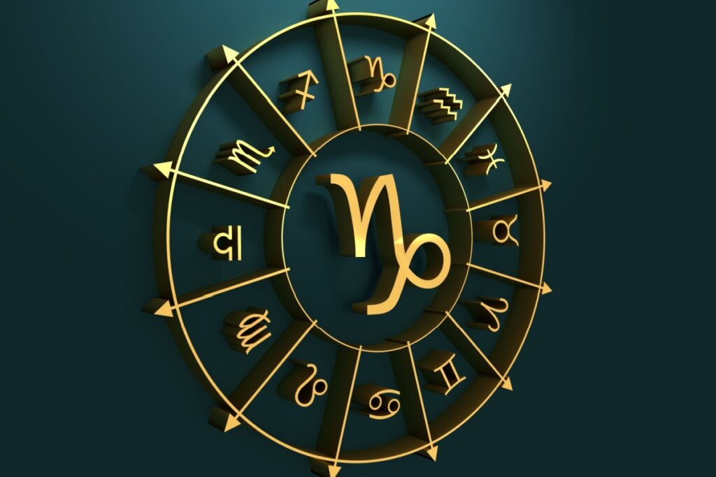 círculo em amarelo com símbolo dos 12 signos em volta, separados por flechas, com símbolo do signo de capricórnio no centro, sobre fundo verde-escuro