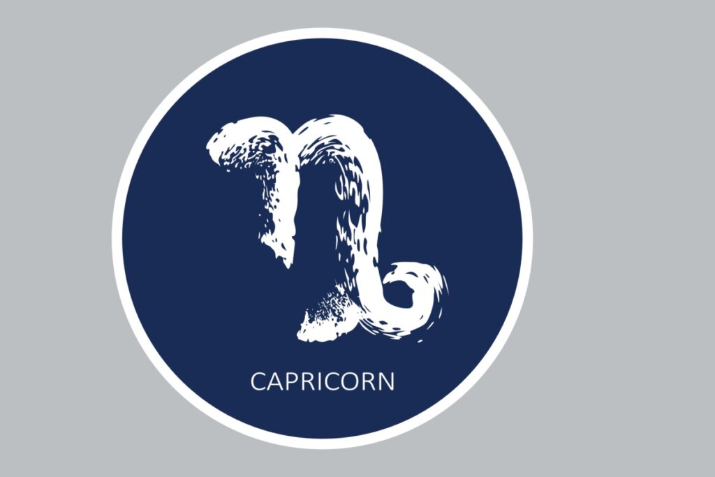 círculo azul-escuro com símbolo do signo de capricórnio e nome dele em inglês na cor branca