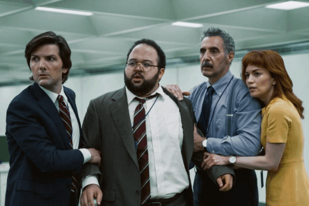 Elenco da série Ruptura; Eles estão próximos uns dos outros, com expressões de tensão, como se estivessem diante de uma situação inesperada ou ameaçadora