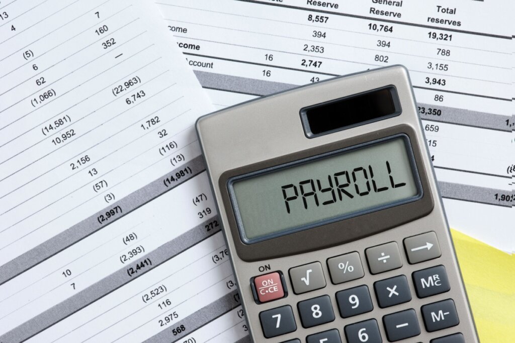 Calculadora em cima de folhas de pagamento 