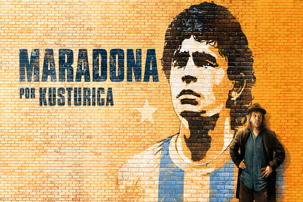 Ilustração do jogador Diego Maradona em parede de tijolos com o nome do documentário e um homem com as mãos na cintura usando roupas de frio e chapéu em frente ao muro