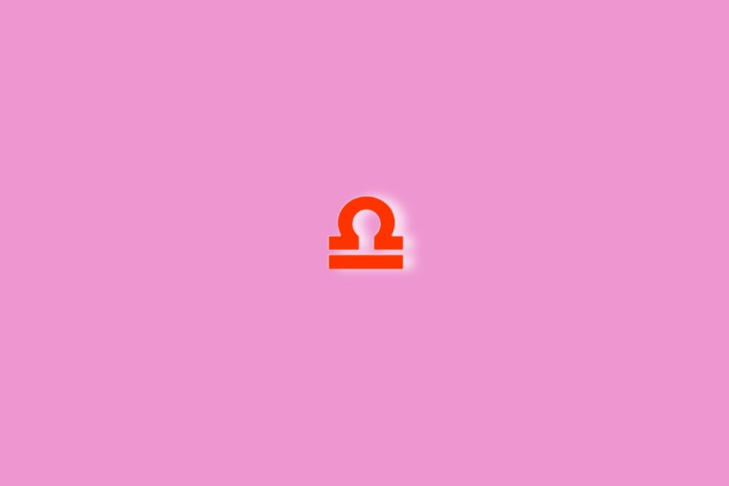 Fundo rosa com o símbolo do signo de libra em vermelho no centro da imagem. Luz branca ao redor dele