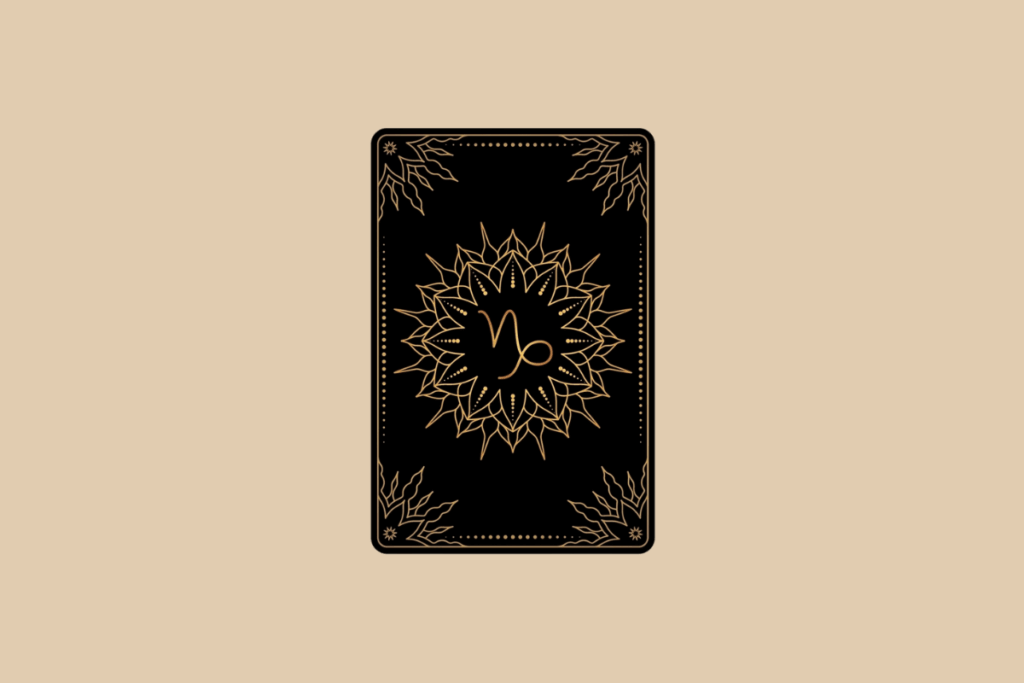 Ilustração de uma carta de tarô preta em fundo bege, com detalhes dourados em mandala e o símbolo do signo de Capricórnio no centro.
