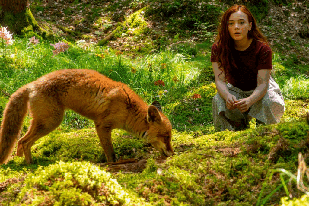 Menina com raposa em floresta em cena de "Willow E A Floresta Encantada"