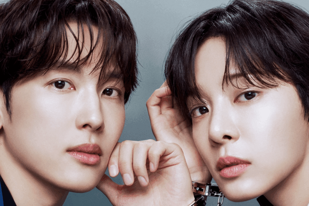 Im Si-wan e Seol In-a, ambos de cabelo escuro com franja, aparecem em close lado a lado diante de um fundo cinza e olham fixamente para a câmera. Ele apoia o queixo na mão, e ela leva a mão à cabeça. Os pulsos dos dois estão presos por algemas prateadas.