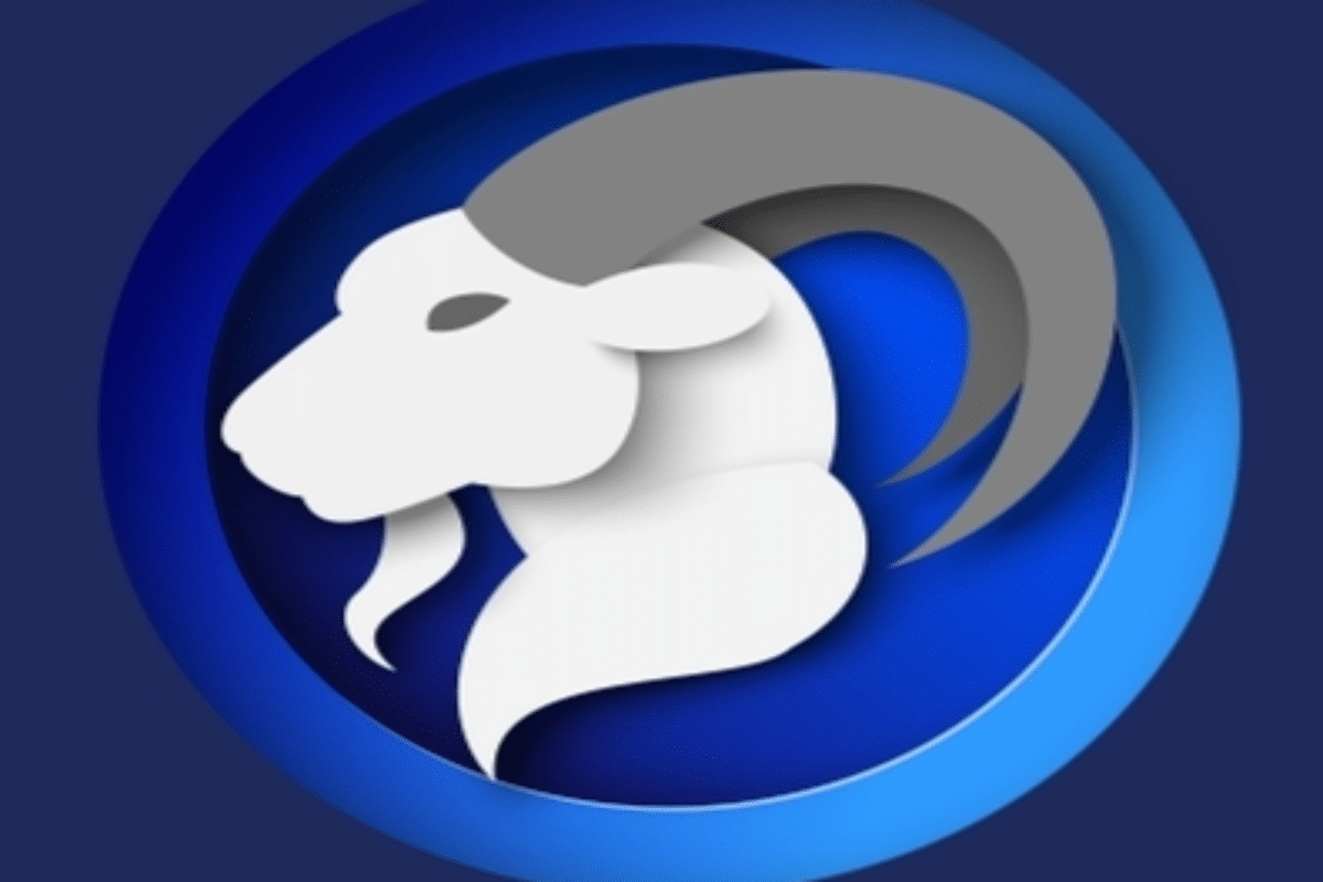 Ilustração do signo de Capricórnio representado pelo perfil de uma cabra branca e cinza, com um grande chifre curvado, sobre um fundo circular azul.