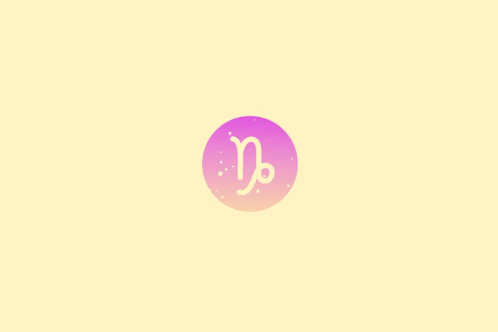 Ilustração minimalista do signo de Capricórnio, representado pelo símbolo estilizado do signo em tom creme. A figura aparece dentro de um círculo em degradê de rosa e lilás, com pequenos pontos decorativos sobre fundo amarelo-claro.
