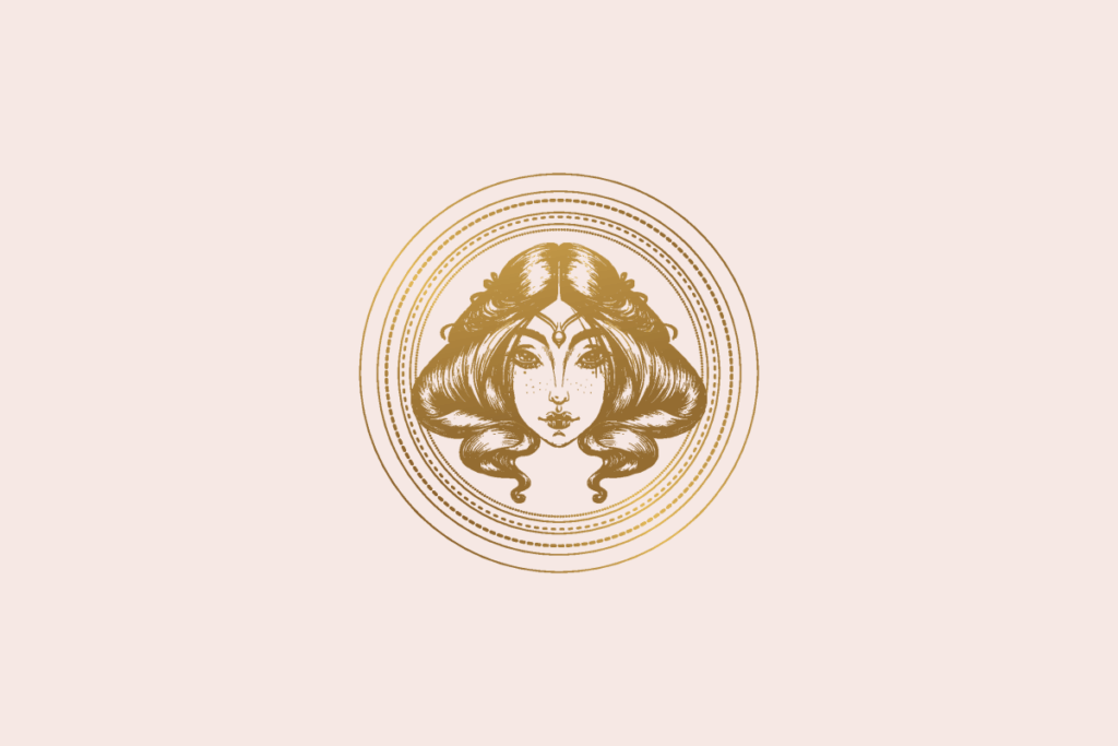 Ilustração do signo Virgem: gravura dourada do rosto de uma mulher de frente, com um enfeite na testa e cabelos longos e ondulados, dentro de um medalhão de anéis dourados finos e pontilhados; em fundo rosa-claro.