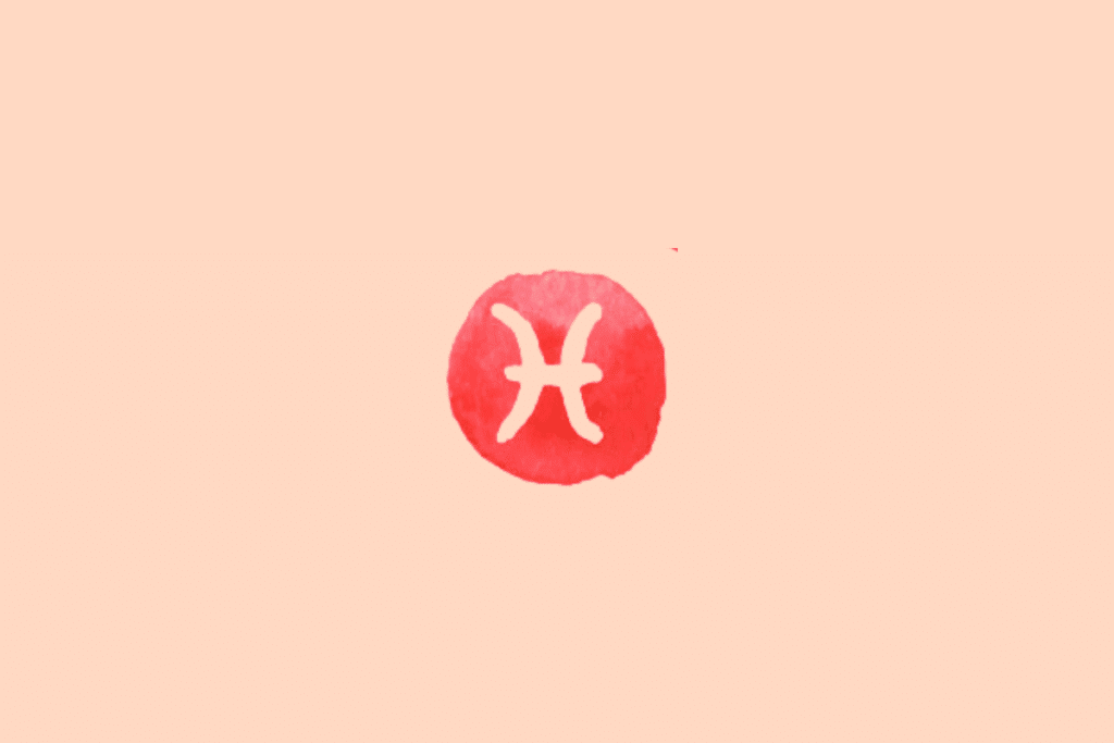 Ilustração do signo de Peixes sobre fundo uniforme em tom pêssego-claro. No centro, há uma mancha circular irregular em vermelho-coral, com textura de aquarela e contornos desiguais. Dentro dela, o símbolo de Peixes aparece em tom creme, formado por duas curvas opostas, voltadas para lados diferentes e unidas por um traço horizontal central. O desenho é simétrico e lembra dois arcos voltados para fora, representando o símbolo tradicional do signo.