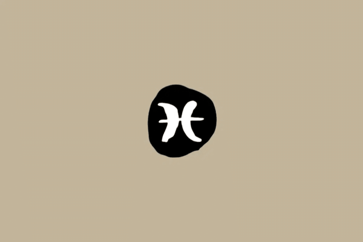 Símbolo do signo de Peixes em branco dentro de um círculo preto sobre um fundo bege 