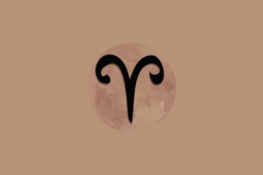 Imagem com fundo bege, apresentando um círculo em tom rosado no centro, com textura que lembra a superfície da Lua. Dentro dele, aparece o símbolo astrológico do signo de Áries em preto, formado por duas linhas curvas que lembram os chifres de um carneiro, unidas em uma ponta alongada para baixo.