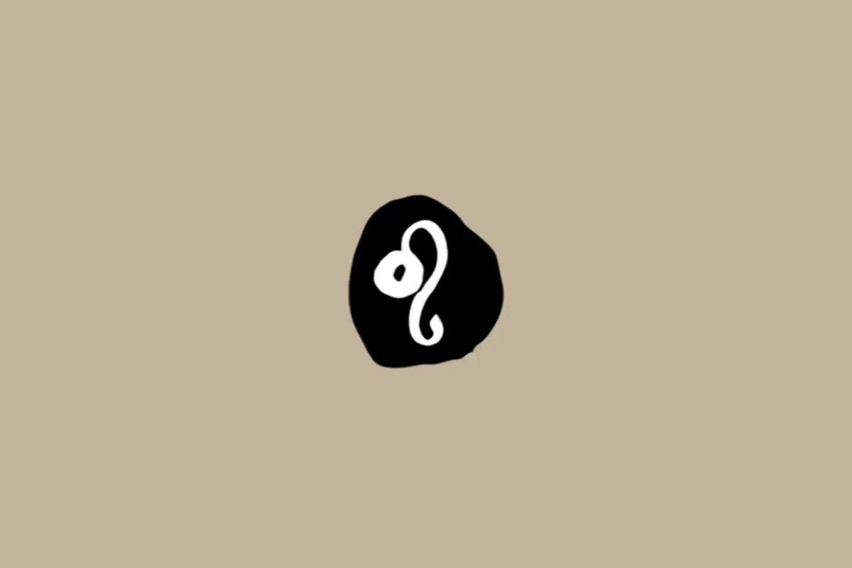 Símbolo do signo de Leão em branco dentro de um círculo preto sobre um fundo bege 