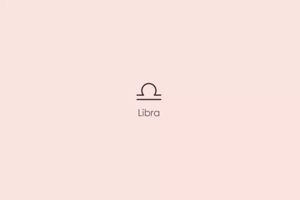 Ilustração minimalista do símbolo astrológico do signo de Libra, formado por um arco sobre duas linhas horizontais, em tom escuro. Abaixo, aparece a palavra “Libra”. O fundo é rosa-claro.