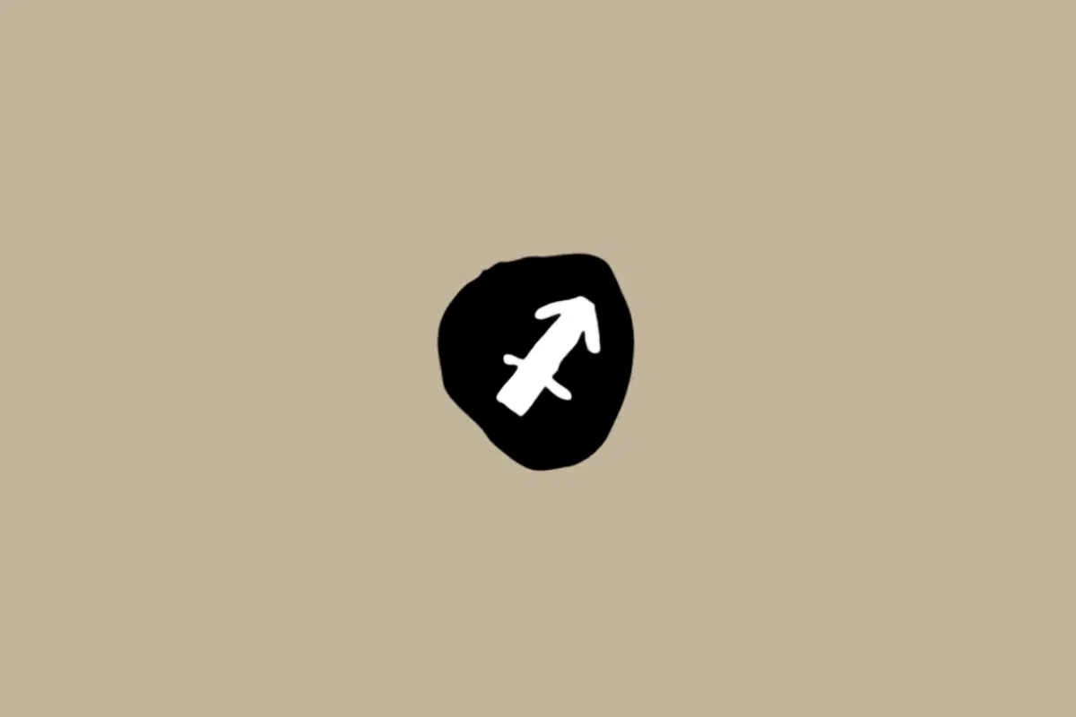Símbolo do signo de Sagitário em branco dentro de um círculo preto sobre um fundo bege 
