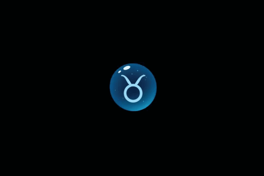 Imagem com fundo preto, apresentando uma esfera azul brilhante no centro, com o símbolo astrológico do signo de Touro em azul-claro, formado por um círculo com duas linhas curvas na parte superior, semelhantes aos chifres de um touro. A esfera possui efeito tridimensional, pequenos pontos luminosos e reflexos brancos na parte superior.